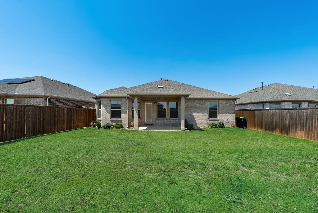 14216 Aberavon Drive Pilot Point, TX 76258 - Photo 19 of 19 Expansive backyard featuring a manicured lawn and a wooden privacy fence