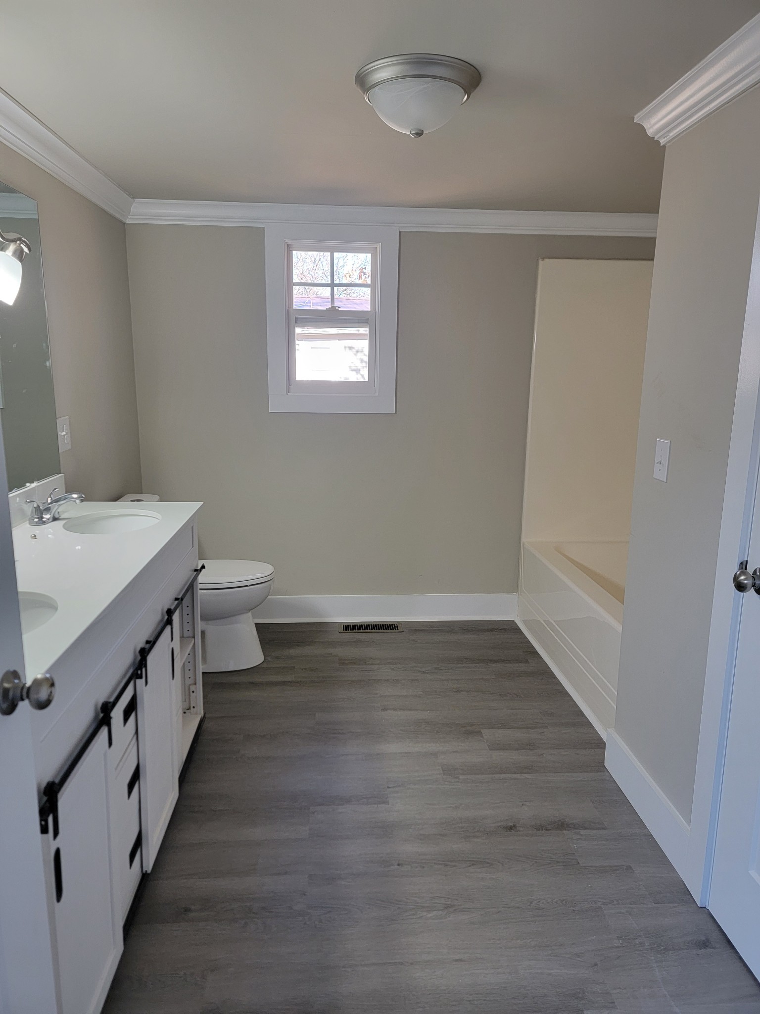 773 Shady Rest Road McMinnville, TN 37110 - Photo 14 of 14 a bathroom with sink a toilet a light fixture and a window