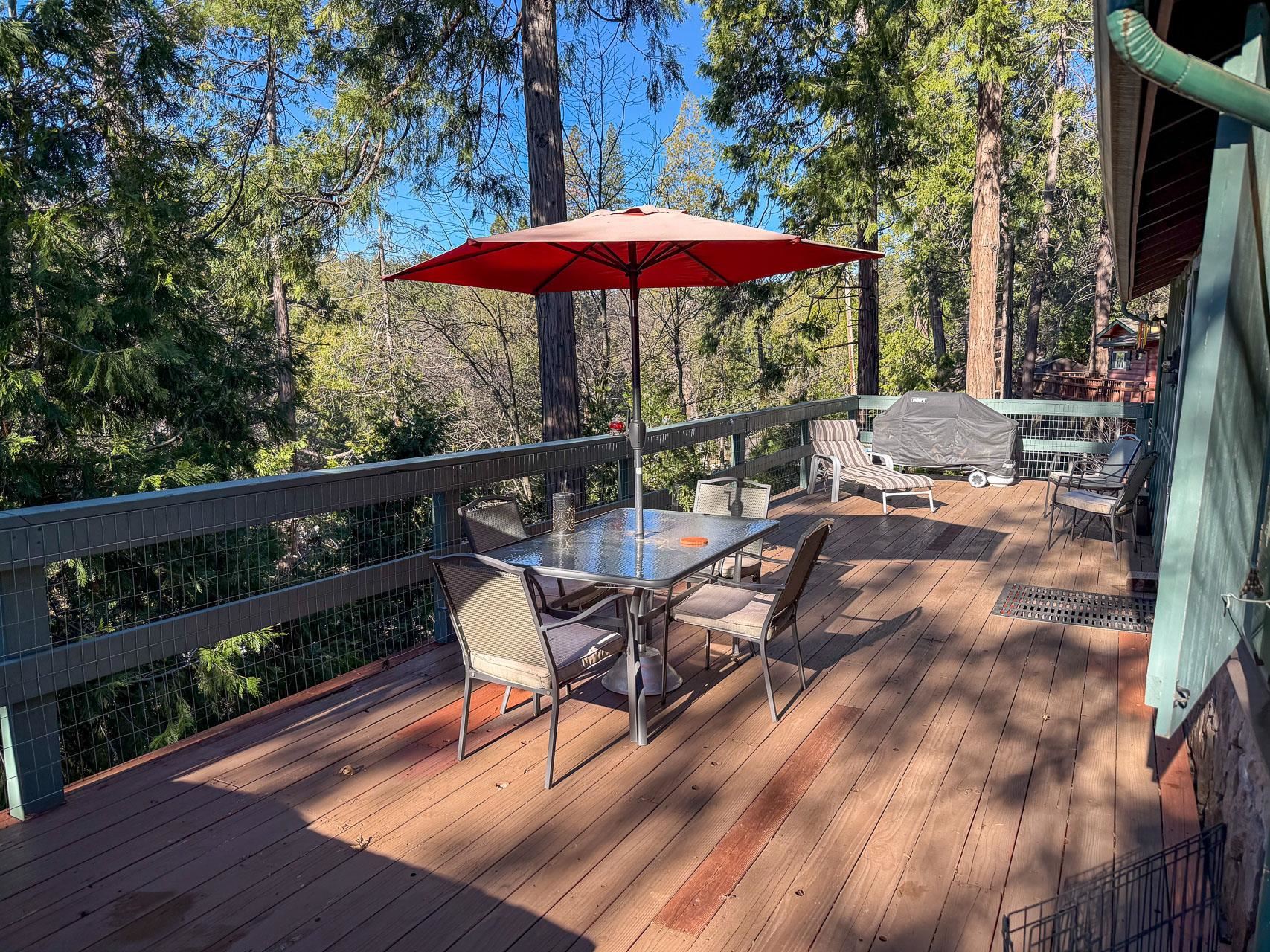 21819 Confidence Road Twain Harte, CA 95383 - Photo 14 of 15 a view of a deck with furniture and barbeque grill with wooden floor