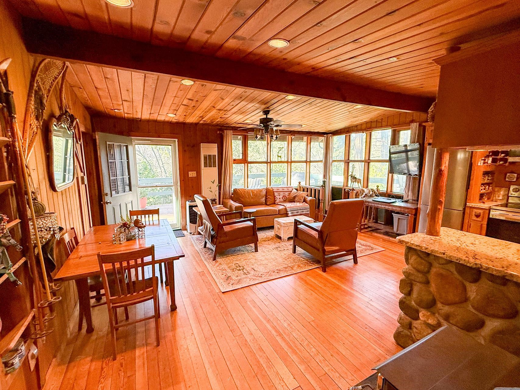 21819 Confidence Road Twain Harte, CA 95383 - Photo 5 of 15 a living room with furniture a wooden floor and next to a window