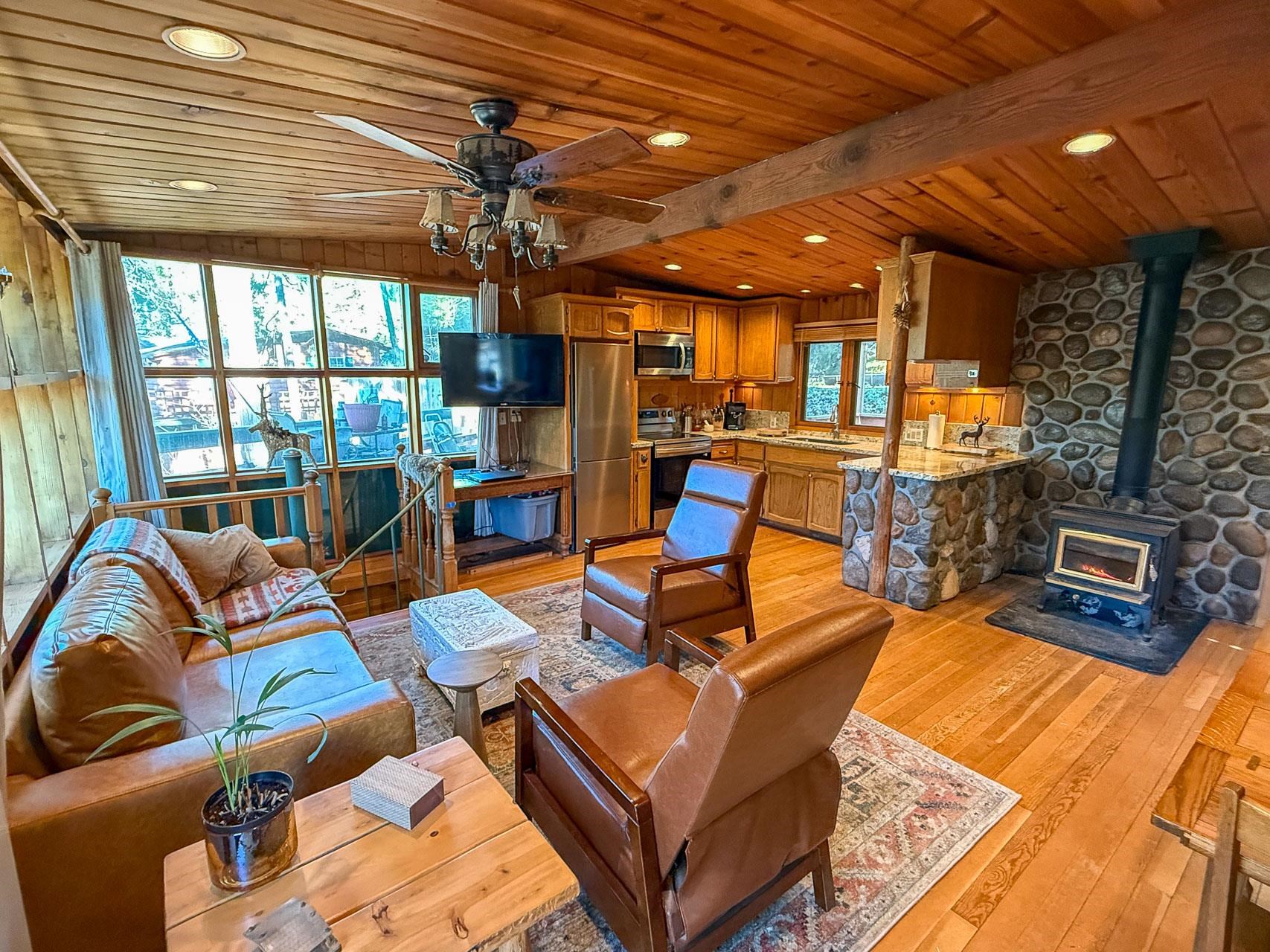 21819 Confidence Road Twain Harte, CA 95383 - Photo 6 of 15 a living room with furniture a large window and chandelier