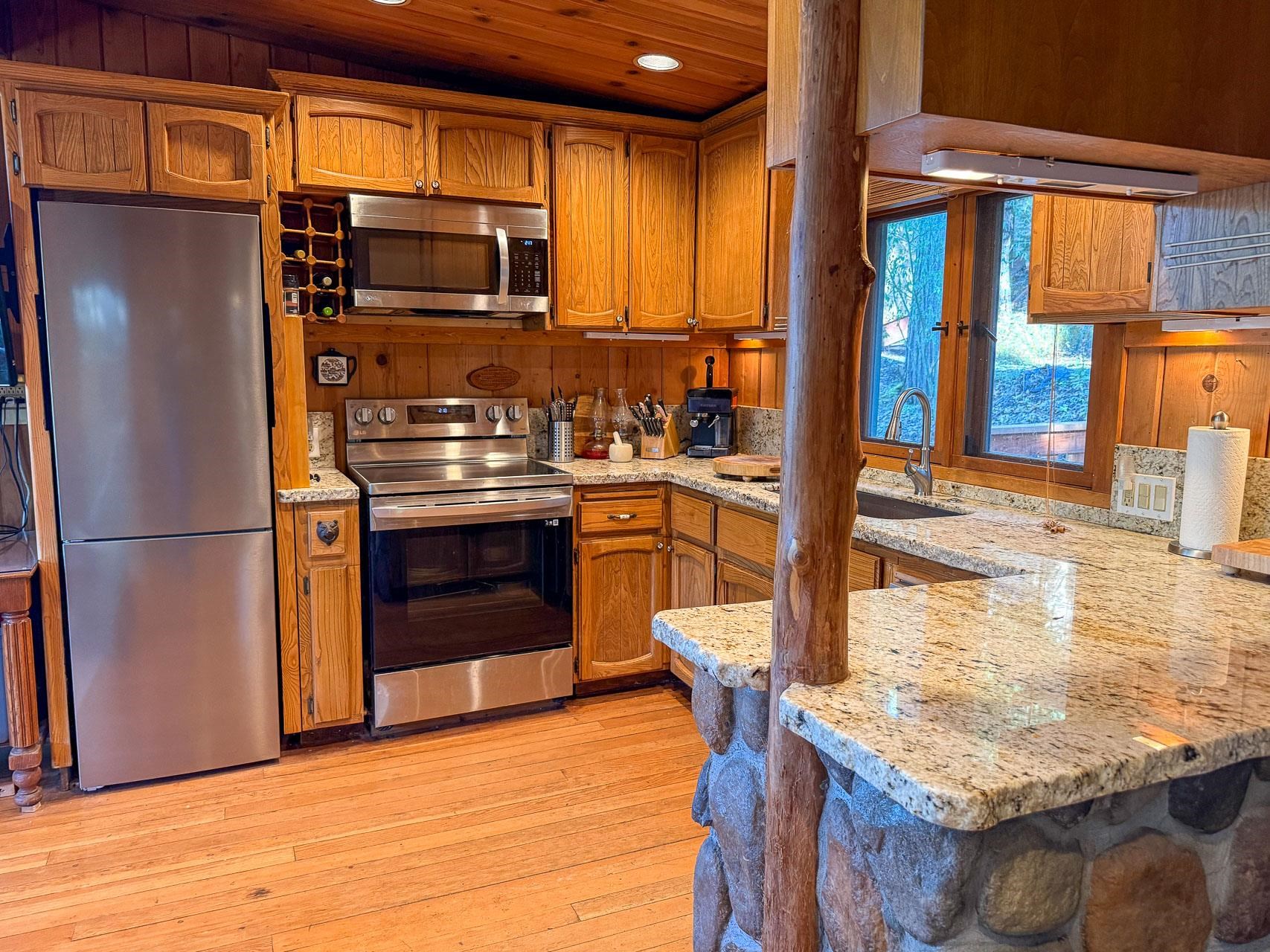 21819 Confidence Road Twain Harte, CA 95383 - Photo 8 of 15 a kitchen with stainless steel appliances granite countertop a refrigerator and a stove top oven