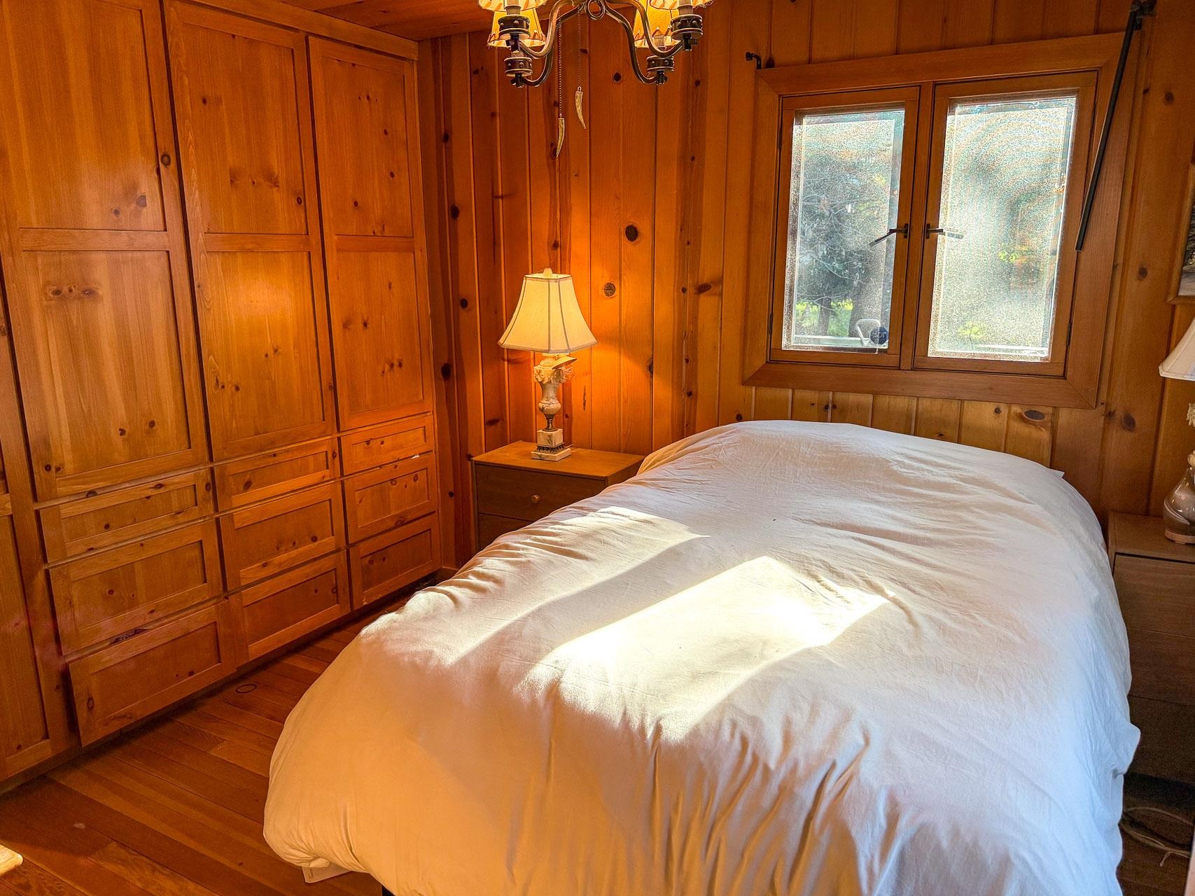 21819 Confidence Road Twain Harte, CA 95383 - Photo 10 of 15 a bedroom with a bed and wooden floor