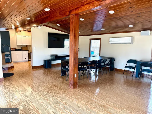 a living room with furniture and view of kitchen
