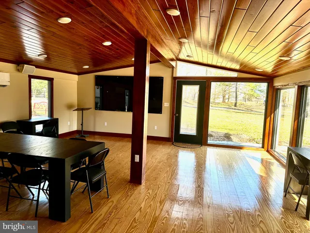 a view of a room with furniture wooden floor and windows