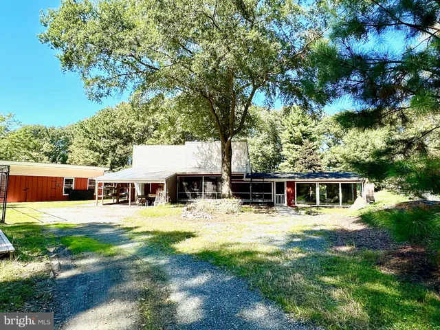 a view of a house with pool and sitting area