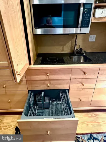 a stove top oven sitting inside of a kitchen