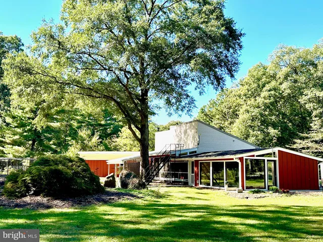 a view of a house with garden and sitting area