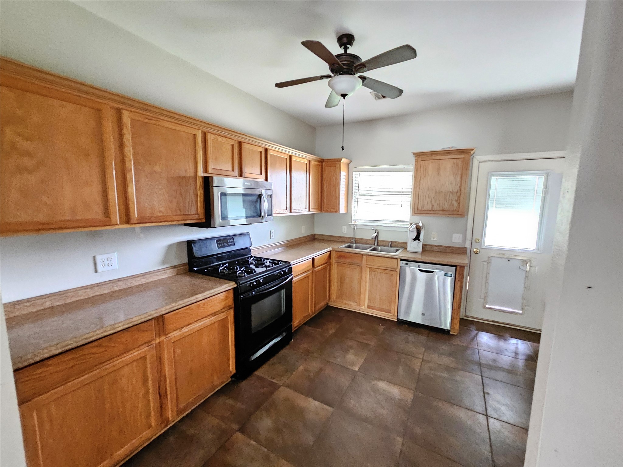 4672 Mather Kyle, TX 78640 - Photo 9 of 28 a kitchen with a stove sink and cabinets