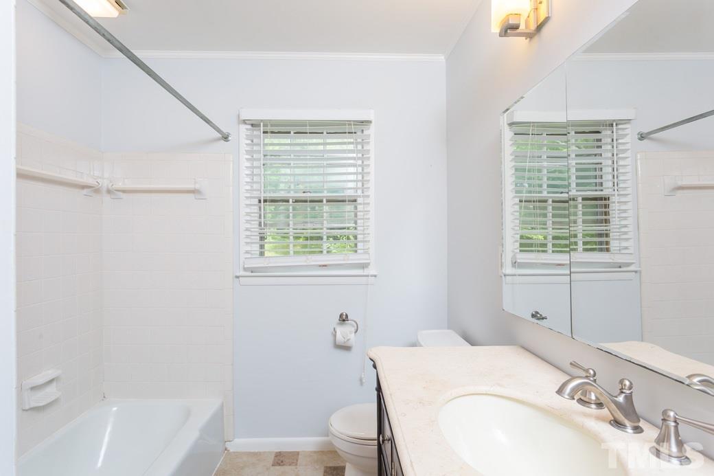 2108 Balboa Road Raleigh, NC 27603 - Photo 14 of 23 The downstairs bathroom has a bath/shower with tile wall.