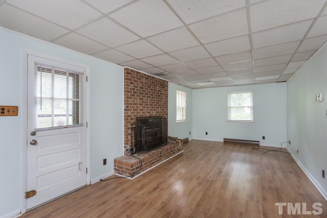 2108 Balboa Road Raleigh, NC 27603 - Photo 16 of 23 The woodstove fireplace will provide ambiance and warmth anytime you like.