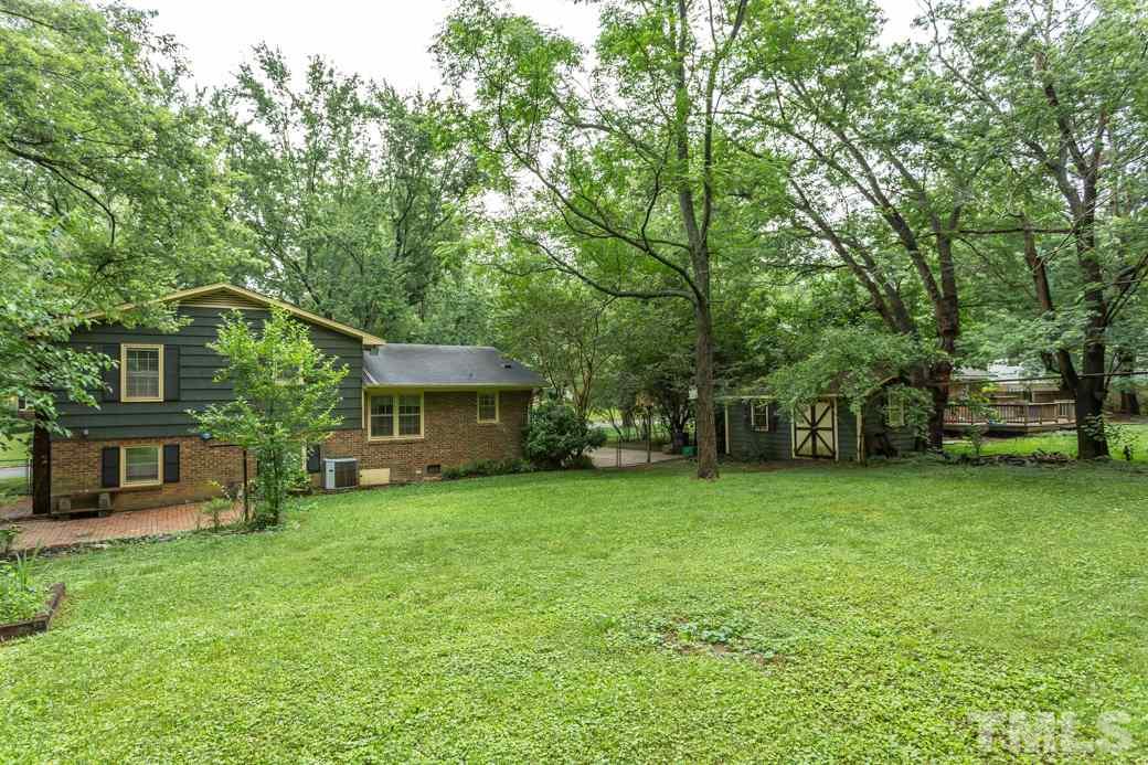 2108 Balboa Road Raleigh, NC 27603 - Photo 21 of 23 Beautiful hardwood trees dot the backyard.