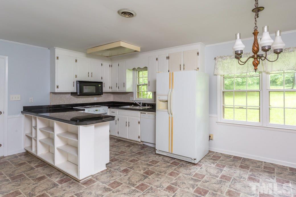 2108 Balboa Road Raleigh, NC 27603 - Photo 6 of 23 Lots of cabinets and shelving under the bar provide storage for all your favorite cookware & cookbooks!