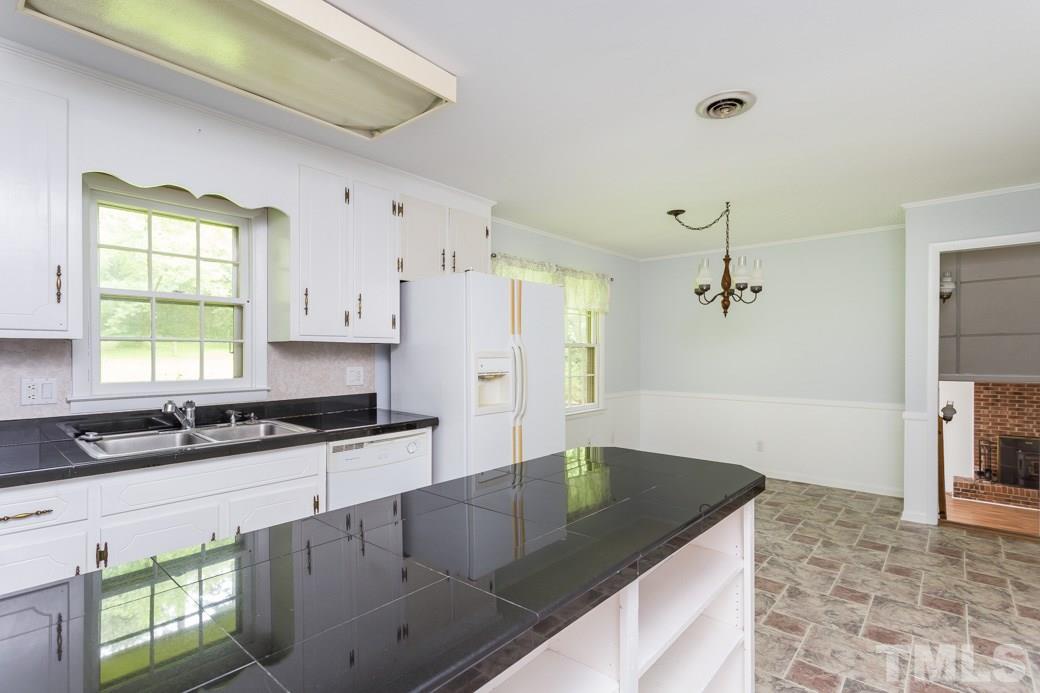 2108 Balboa Road Raleigh, NC 27603 - Photo 9 of 23 The kitchen stays light and bright since it is open to the dining space and side door.