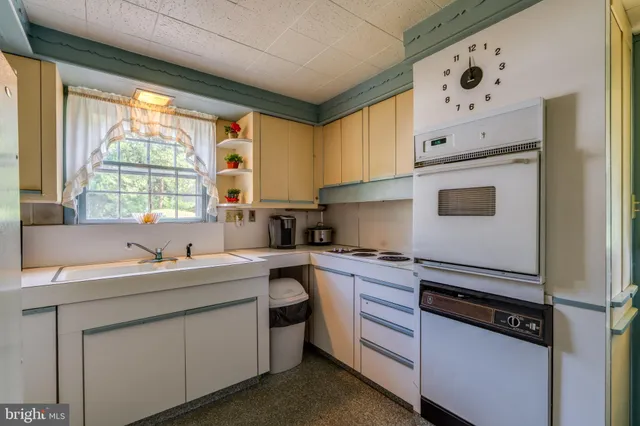 a kitchen with stainless steel appliances a sink stove and window