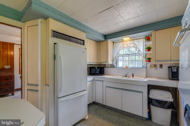 a kitchen with a sink appliances and cabinets