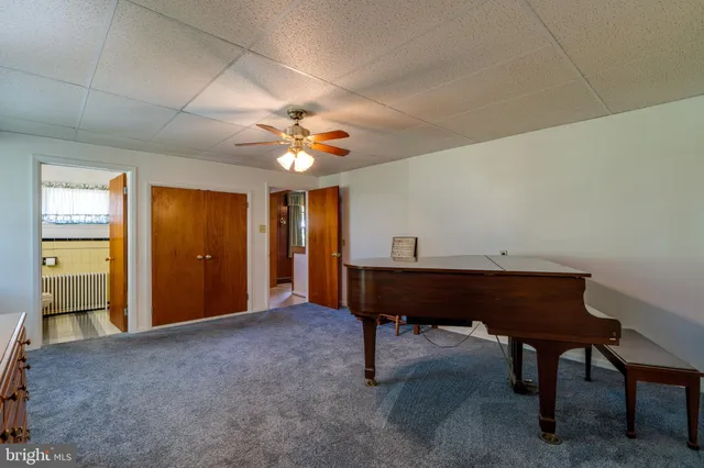 a view of a workspace with furniture and a chandelier
