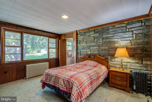 a bedroom with a bed and window