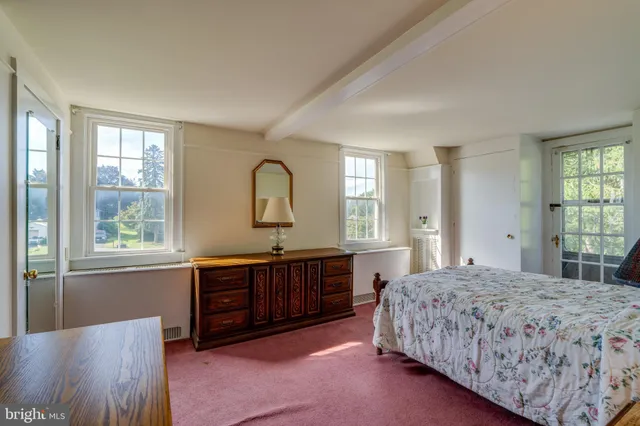 a spacious bedroom with a large bed and a window