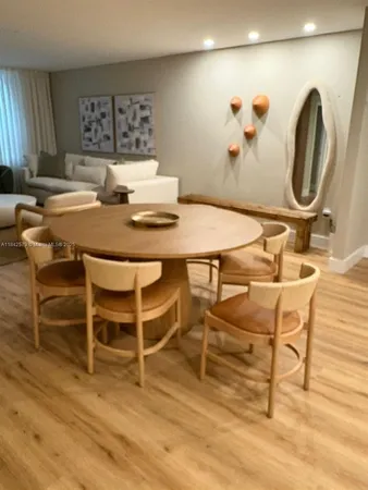 a dining room with furniture and wooden floor