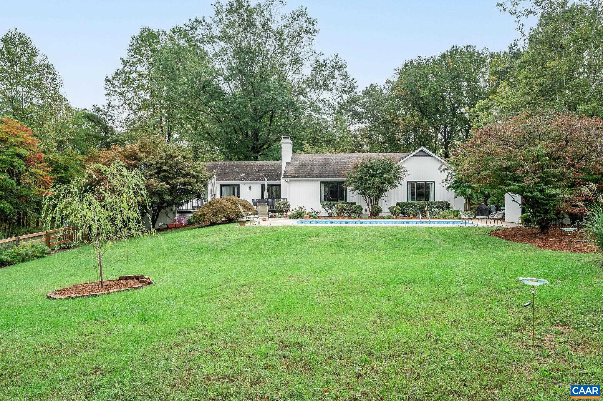 a view of a house with a backyard and a patio
