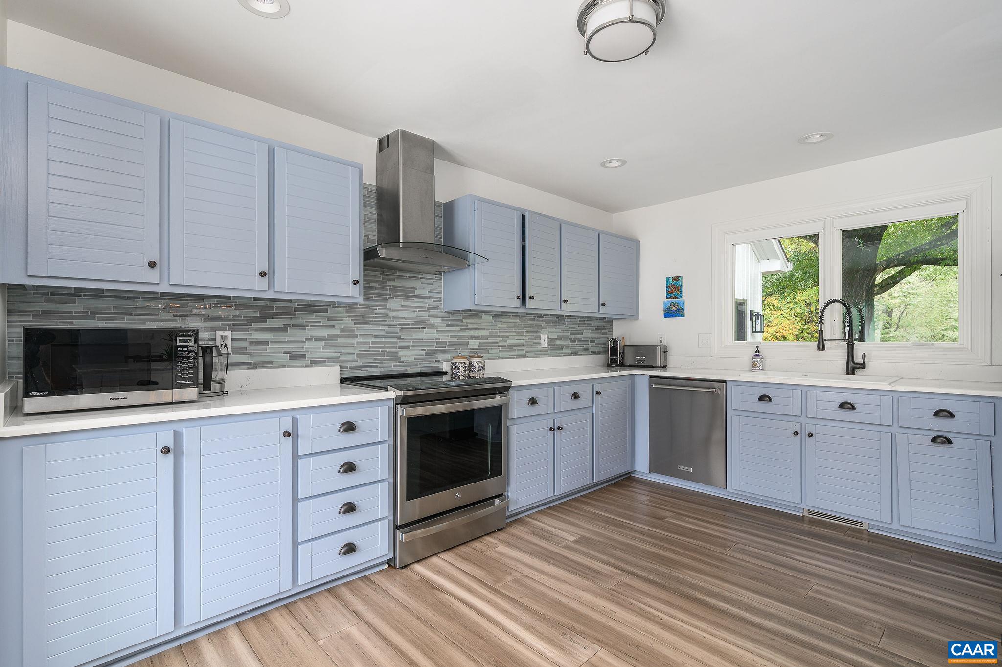 2795 Pea Ridge Road Charlottesville, VA 22901 - Photo 14 of 54 a kitchen with granite countertop a sink cabinets stainless steel appliances and a window
