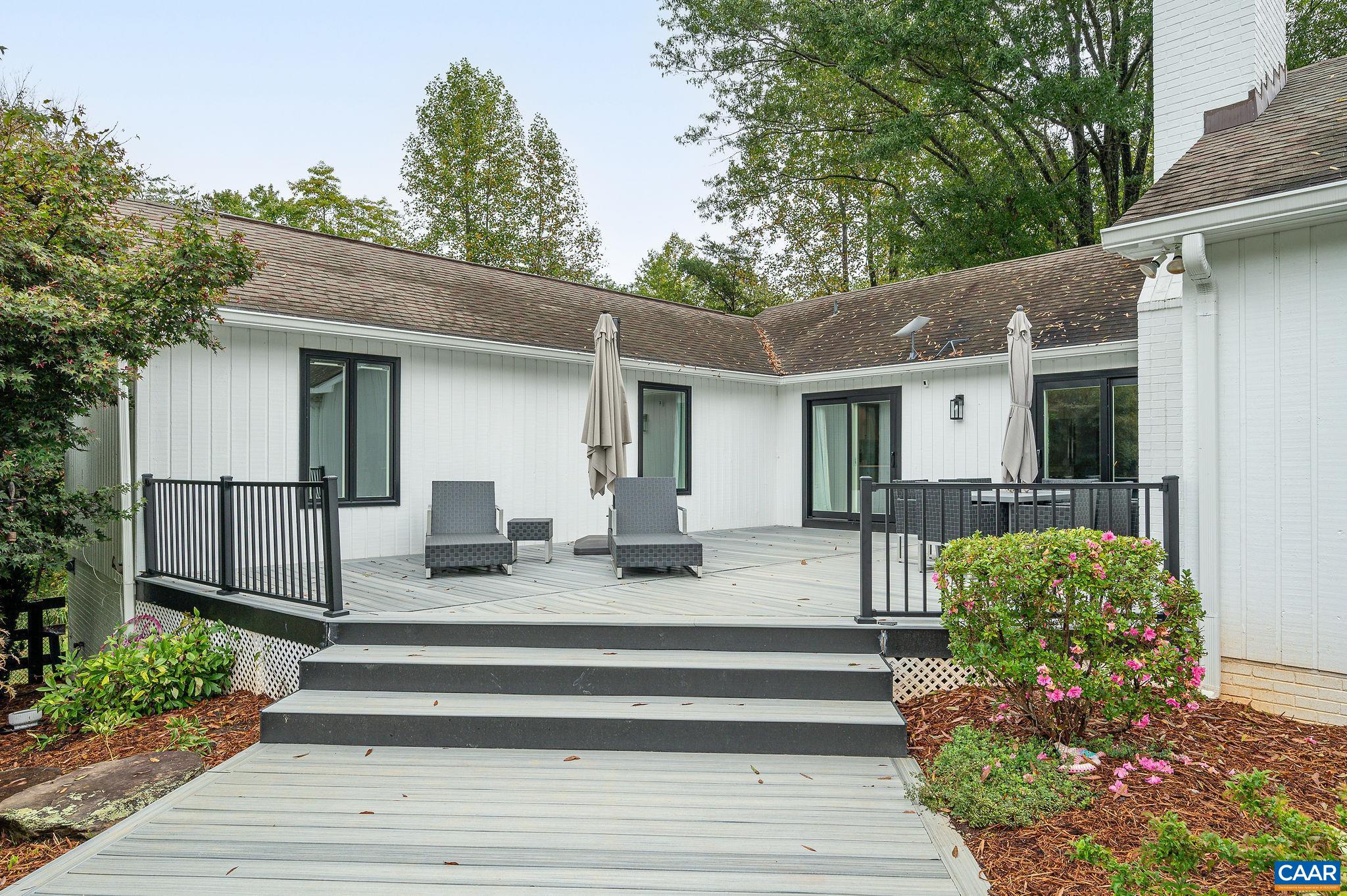 2795 Pea Ridge Road Charlottesville, VA 22901 - Photo 5 of 54 a front view of a house with a garden and plants