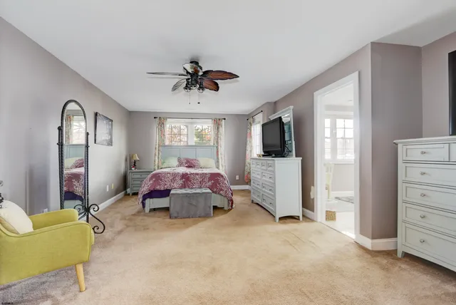 a bedroom with a bed a couch and dresser