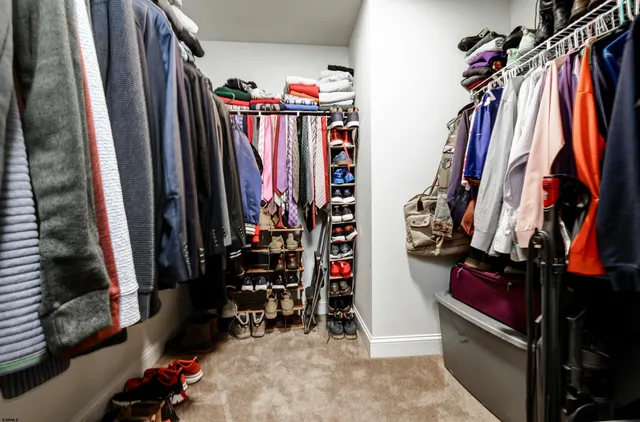 a view of walk in closet with clothes