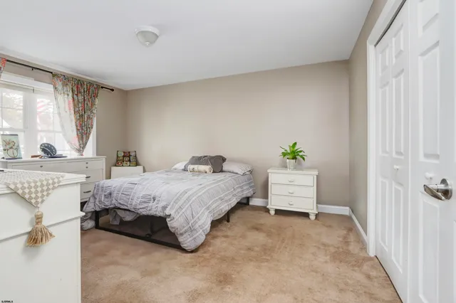 a spacious bedroom with a bed and a window