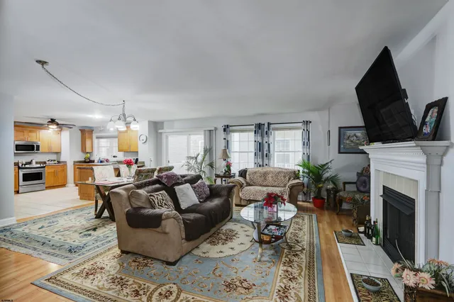 a living room with furniture a fireplace and a flat screen tv