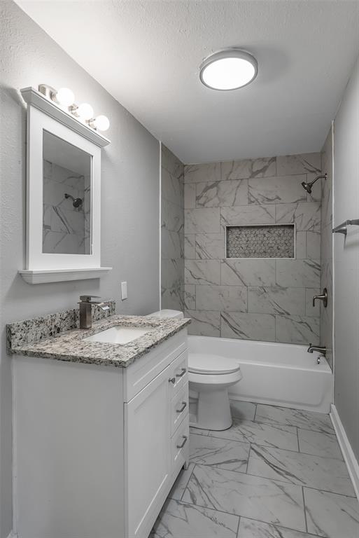 224 Prysock Road Doyline, LA 71023 - Photo 21 of 38 Full bathroom featuring vanity, light marble finish floors, a combined bath / shower with marble appearance, and a textured ceiling