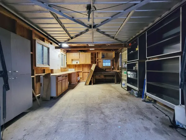 a view of empty room with wooden walls