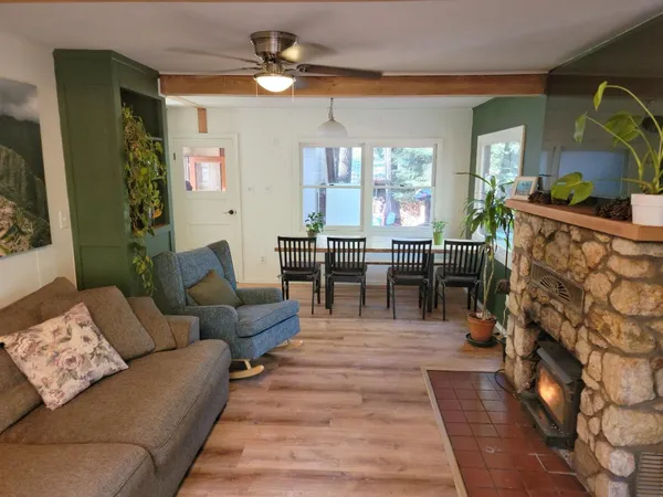 a living room with furniture dining table a chandelier and a fireplace