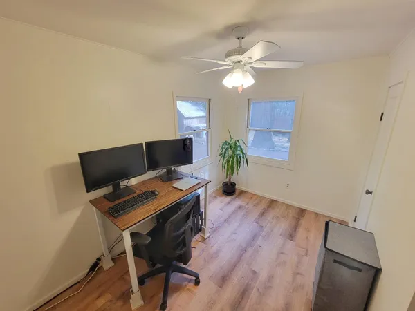 a workspace with furniture and wooden floor