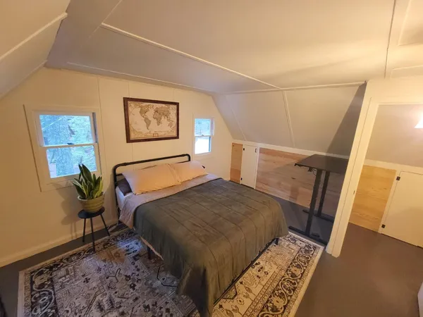 a bedroom with a bed and a rug