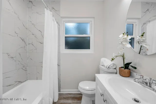 a bathroom with a bathtub and shower