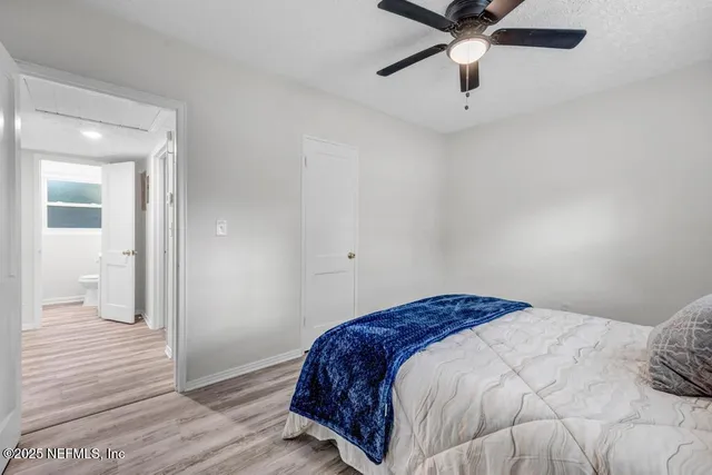 a bedroom with a large bed and a window