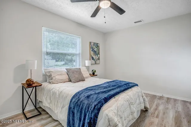 a bedroom with a large bed and a window