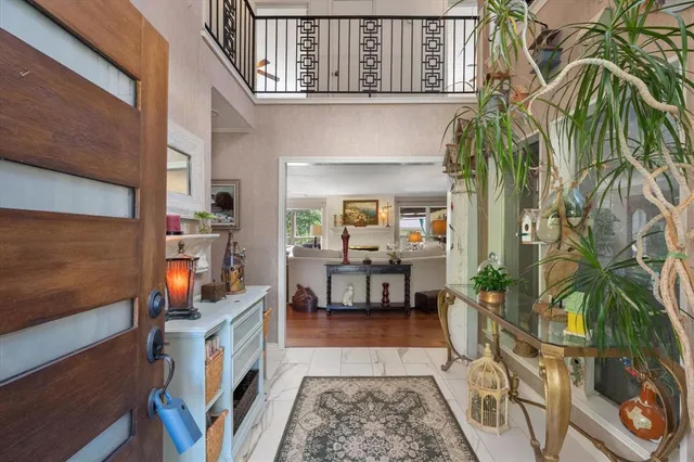 a living room with patio outer view and potted plants