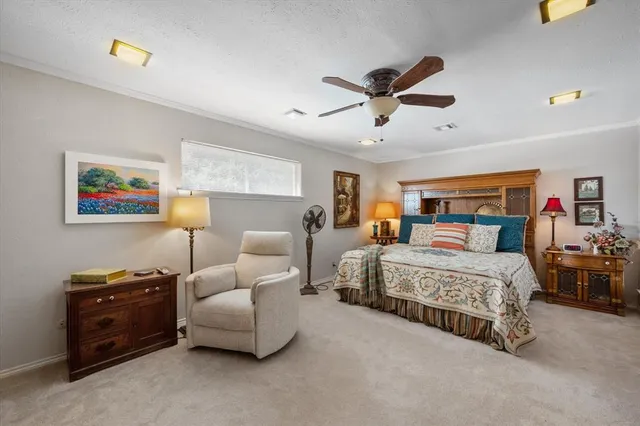 a spacious bedroom with a bed and a chandelier