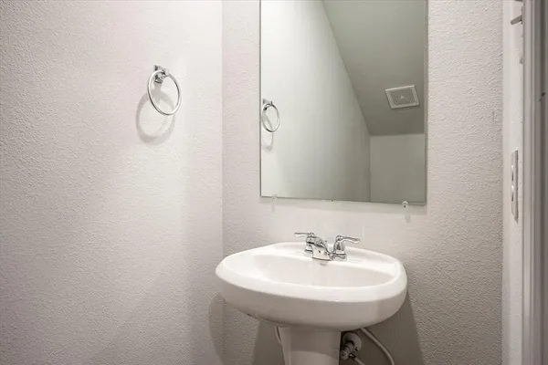 a bathroom with a sink a mirror and a toilet