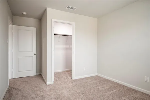 an empty room with closet area