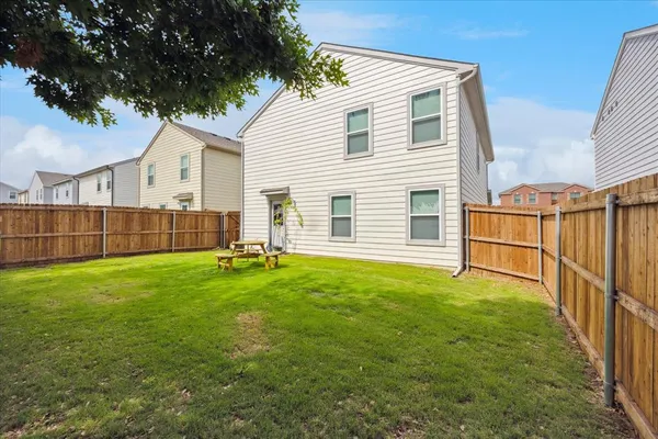 a view of a backyard with a garden and entertaining space