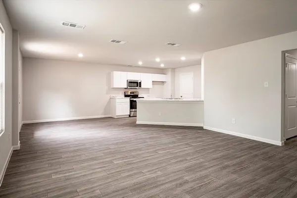 a view of a kitchen with a sink and a refrigerator