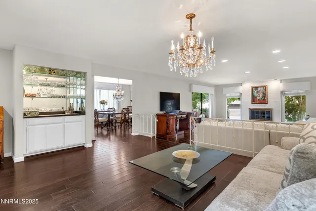 a living room with furniture and a chandelier