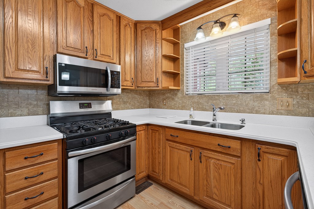 80 Sowers Road Blue Ridge, GA 30513 - Photo 12 of 58 a kitchen with granite countertop stainless steel appliances a stove sink and microwave