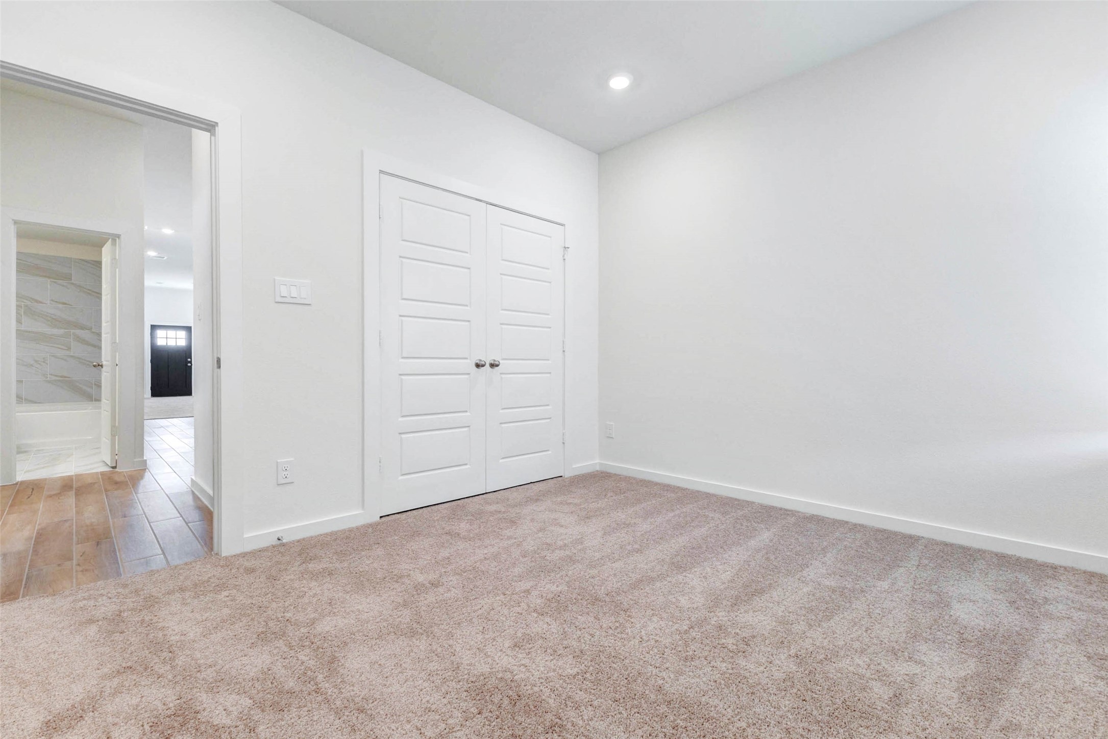 6463 Escondido Drive Rosharon, TX 77583 - Photo 18 of 30 Additional secondary bedroom with plush carpet, neutral walls, recessed lighting, and a double-door closet. The room offers a clean, move-in-ready feel and can easily serve as a bedroom, office, playroom, or guest space.