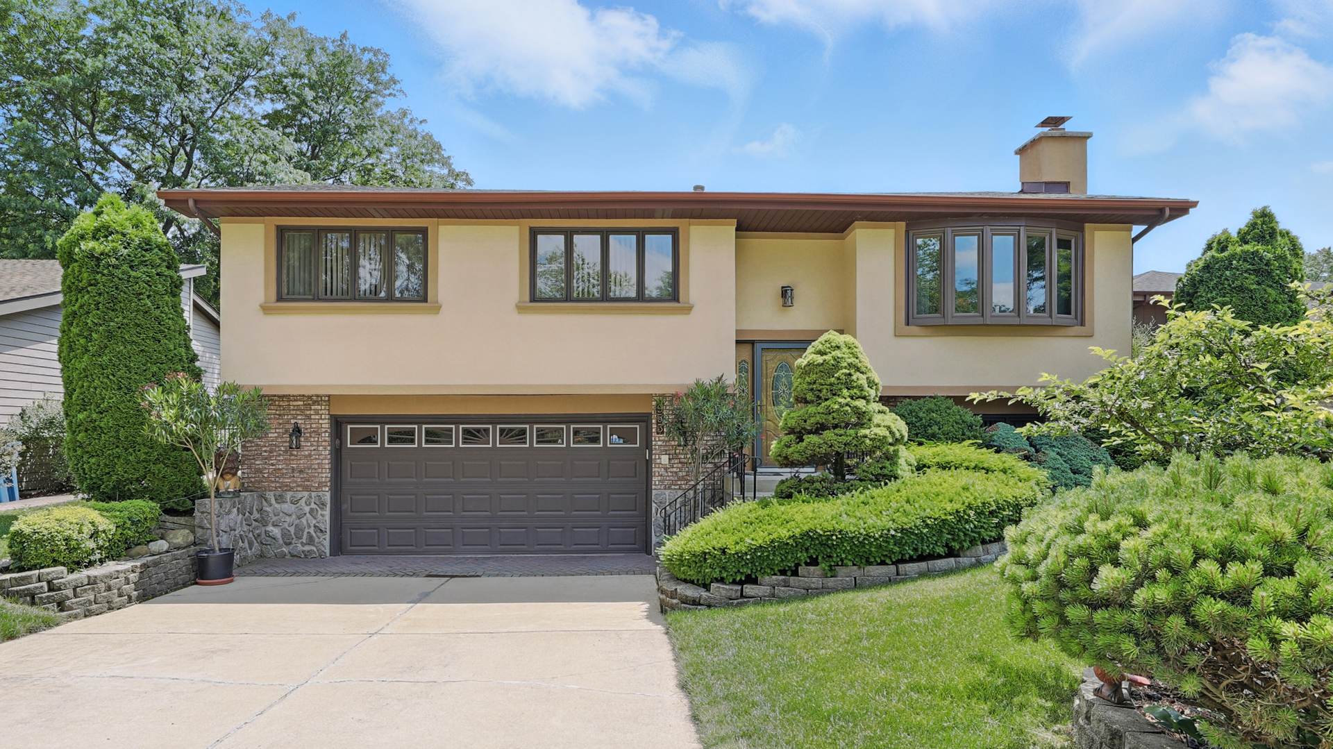 a front view of a house with a garden
