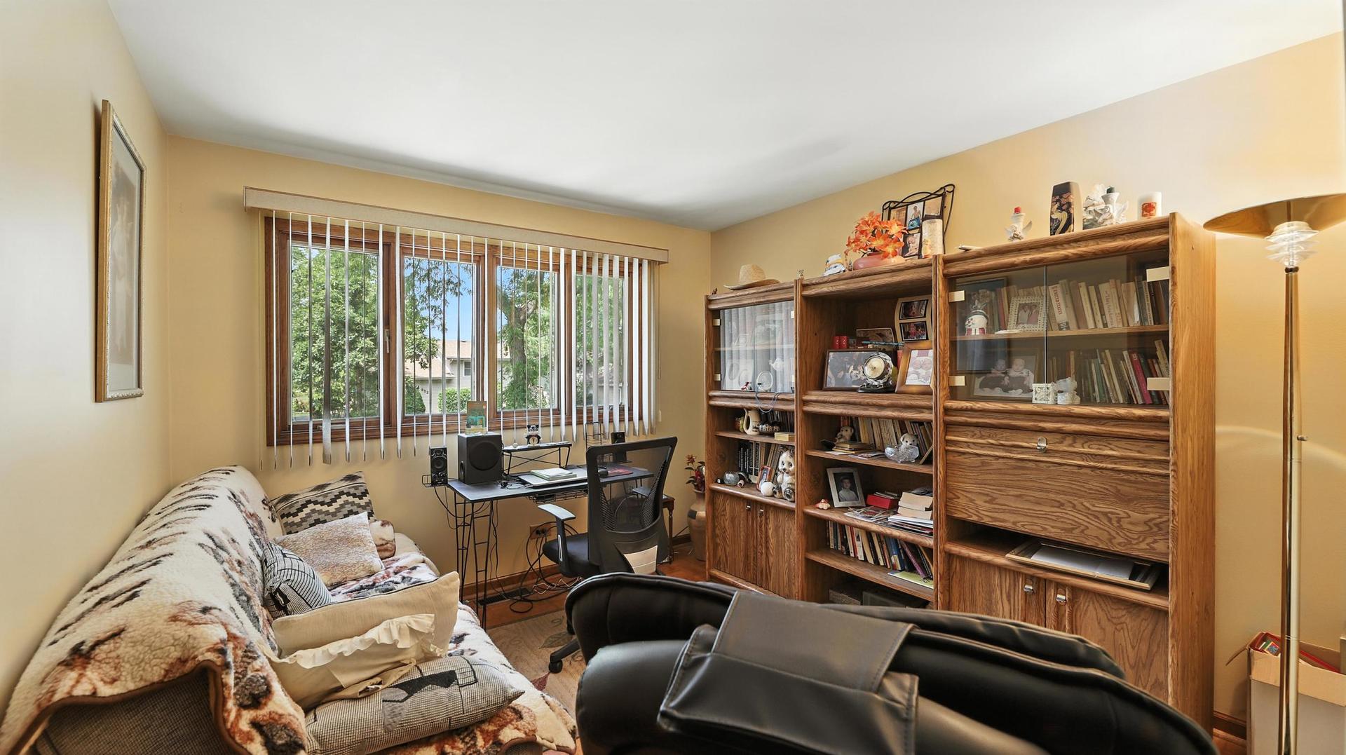 953 Surrey Road Addison, IL 60101 - Photo 13 of 21 a living room with furniture a flat screen tv and a window
